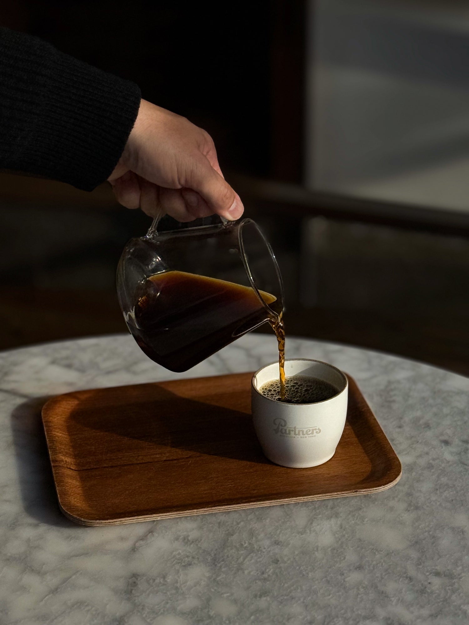 Partners Coffee and Kinto collab image displaying coffee being poured into a cup