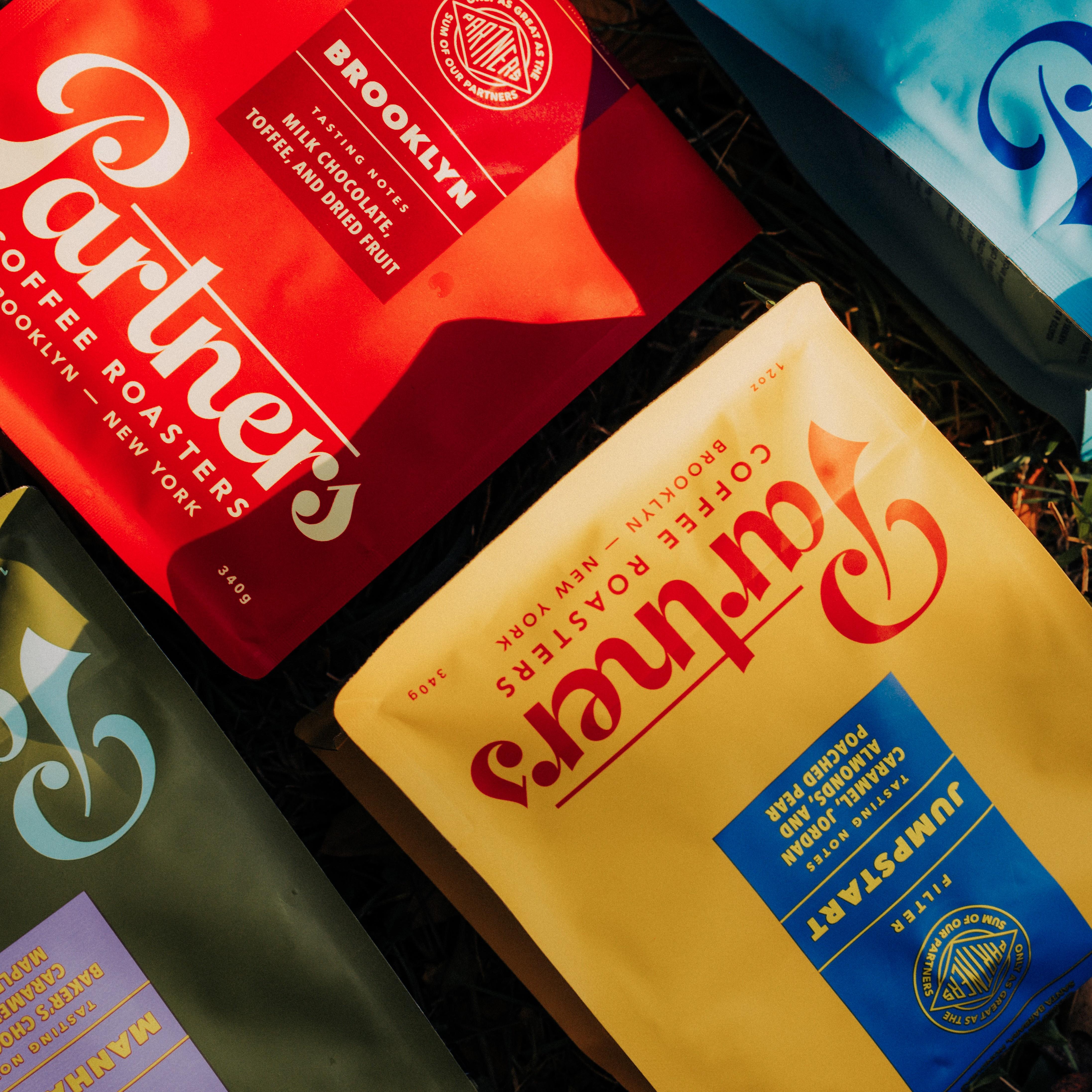 Colorful bags of Partners Coffee bags for Brooklyn, Manhattan, Jumpstart, and Colombia - El Ramo.