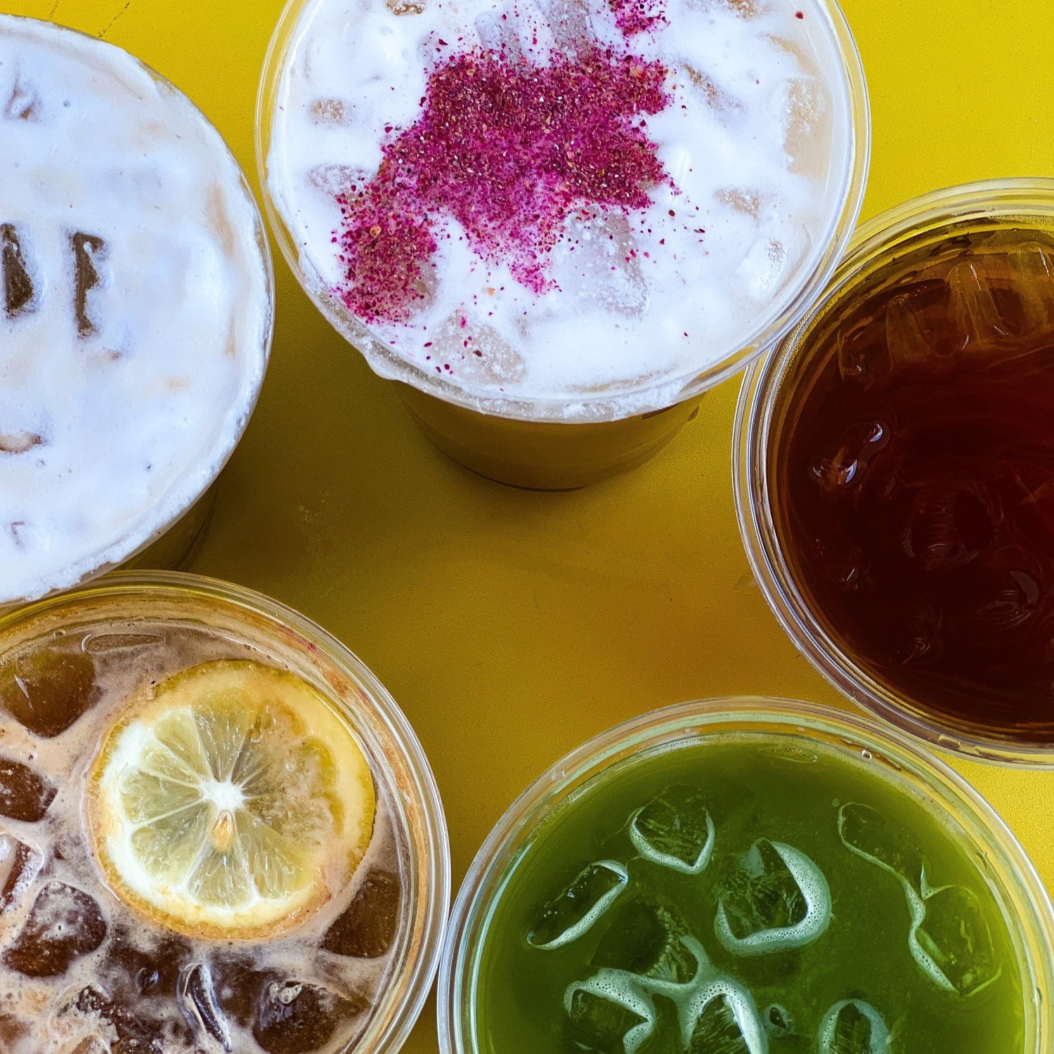 Overhead image of 5 different coffee drinks